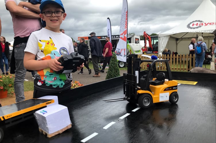 Mini forklifts on trade stand pull in young fans- Charlie Nicholas of Liskeard on West Exe Forklifts stand