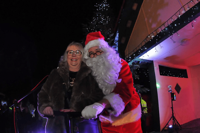 Mayor Cllr Lisa Mayne switches on the Christmas lights, with a little help from Father Christmas 