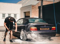 Young farmers on hand with bucket and sponge for charity car wash