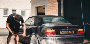 Young farmers on hand with bucket and sponge for charity car wash