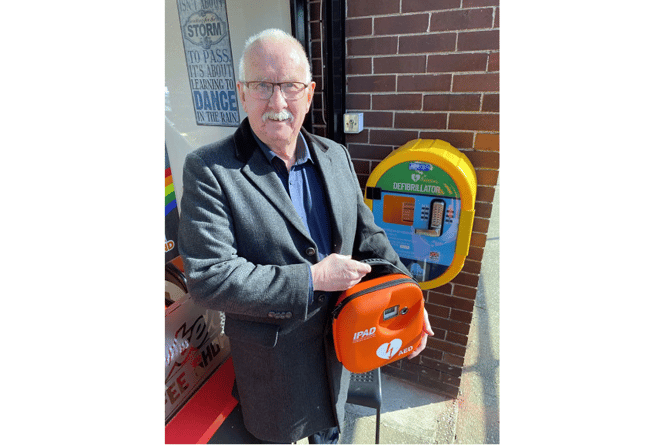 Cllr Mike Ryan with one of the defibrillators.