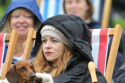 Revellers brave wet weather to watch Coronation at Powderham Castle