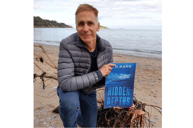 Jason Mann with his novel