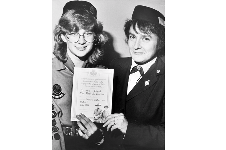 Alison Crook of 2nd Dawlish Guides receives her Baden Powell Trefoil badge and certificate from District Commissioner Maureen Hutchings.