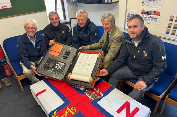 Teignmouth RNLI volunteers Brian Harnett, Alan Harwood, Adrian Knowles, Lord Clifford and Matt Slader sign 200th Anniversary Scroll. Photo: RNLI