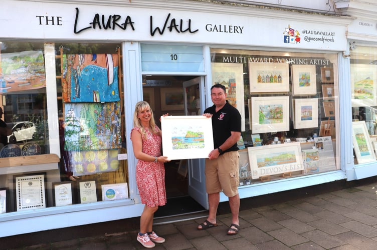 Laura Wall presents 'Seaside Scrum' to Teignmouth Rugby Club Chair Mark Brookfield (photo: Lorna Gray)