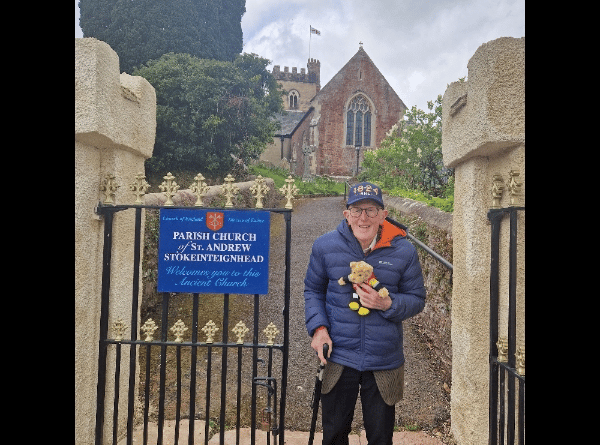 Retired vicar Marcus Braybrook with his RNLI teddy outside Stokeinteignhead Parish Church