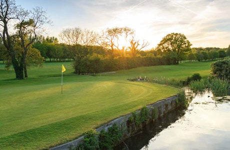 Dainton Park's 1st green bathed in sunlight