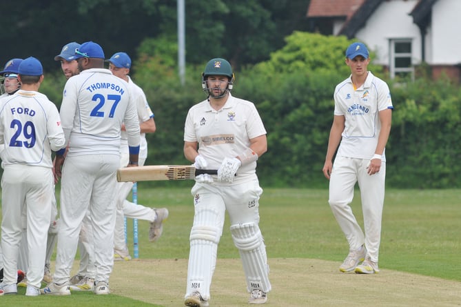 Devon Cricket League Premier Division.  Bovey Tracey versus Sandford. Bovey's Lewis Hammett iheads to th pavilion after caught behind by Adam Small from a ball off Aryan Lakra