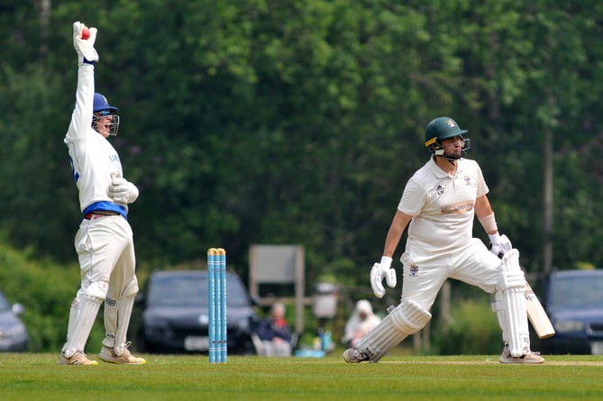 Devon Cricket League Premier Division.  Bovey Tracey versus Sandford. Bovey's Lewis Hammett and Sandford keeper Adam Small