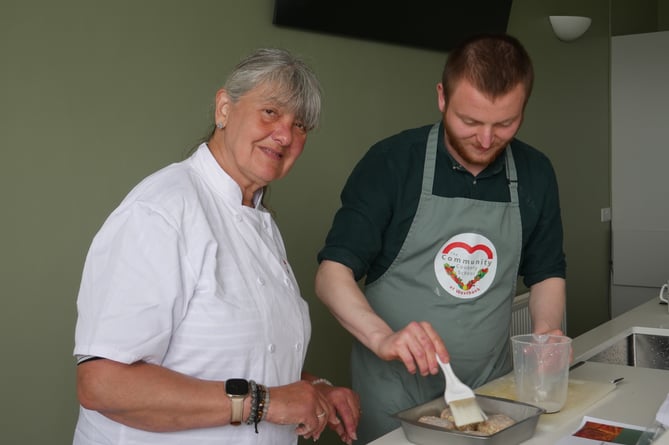 Westbank volunteer Sue Worthington-Dickason teaching in the Community Cookery School 