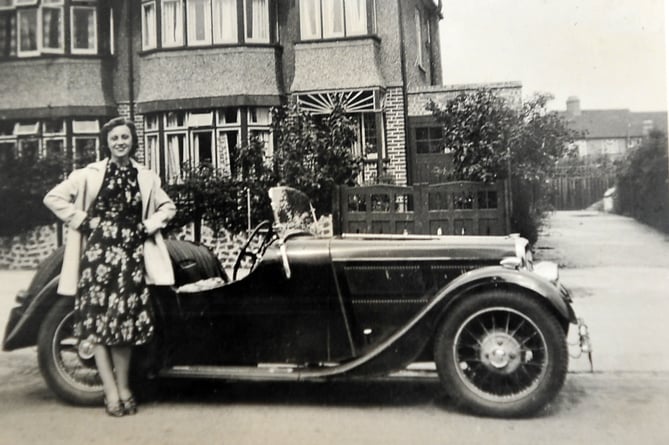 Bishopsteignton resident Poppy Scott  who reached the impressive age of 107 years young  this week. Collect image of Poppy with a Bugatti in the late 1930s