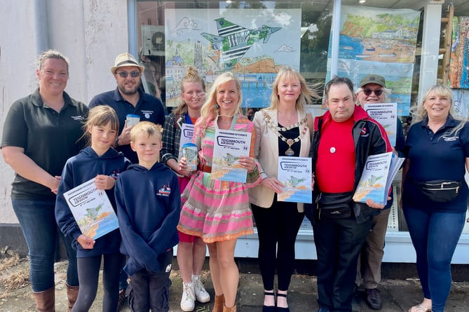 Teignmouth Airshow committee with artist Laura Wall, mayor Cate Williams and deputy mayor Chloe Myers at the launch of the 2024 Teignmouth Airshow programme.