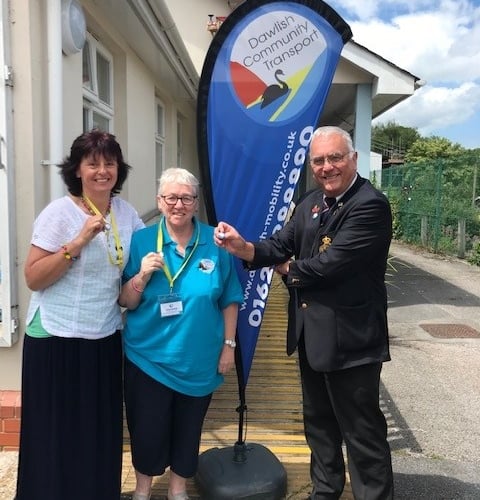 Sally Preston (office manager), Kathy Thornton (Admin volunteer) and Richard Hayward of Dawlish presenting the pin badges.