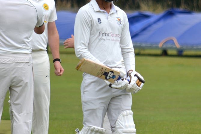 Budleigh Salterton fielders celebrate in the background after Chudleigh batsman Manroz Bhullar was dismissed cheaply in the game at Kate Brook