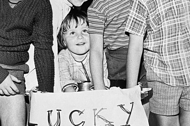 Archive.   Cheap at half the price - which would have been tuppence. Youngsters manning the lucky dip stand at Teignmouth Rotary Club Fete in August 1973