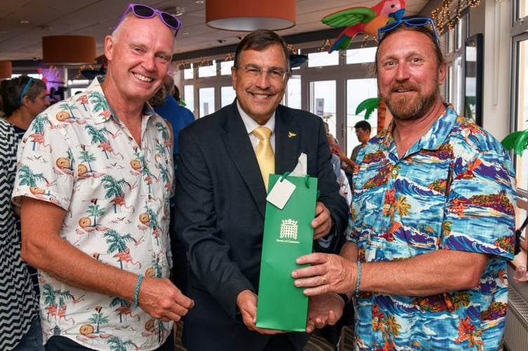 Martin Wrigley MP (centre) presents Andy Purvis (L) and Tim Cox (R) with a bottle of House of Commons champagne for their fundraising auction.