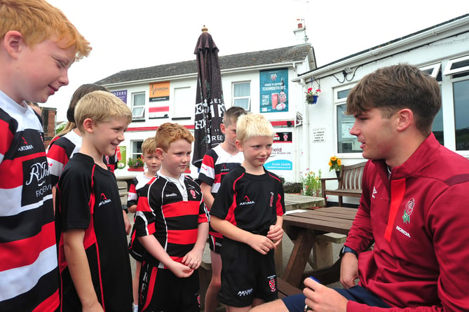 Ben Coen, of England's  Under-20 World Rugby Championship winning team, with young members of Teignmouth Rugby Club