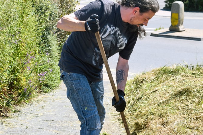 Guerilla gardener Dan Comer tidies up the overgrown verge opposite Teignmouth fire station