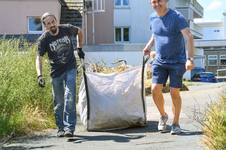 Teignmouth Town Councillors Dan Comer and Mike Jackman with a large bag of cuttings