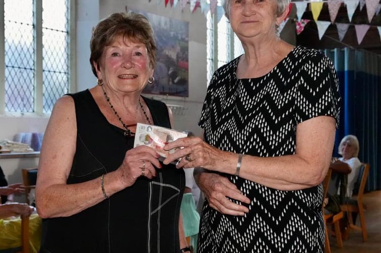 Carole Tamlyn (left) presents donation to Meg Salter. Photo Bob Simpson 