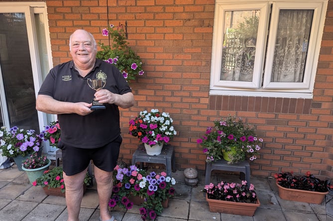 Keith Maclean celebrates after his container garden won the 2024 Teign Housing in Bloom competition