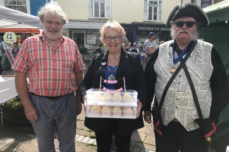 L-R Farmers' Market chair David Lamboll, Former Mayor of Teignmouth Joan Atkin and Town Crier Patrick Brophy celebrating the market's birthday last August.