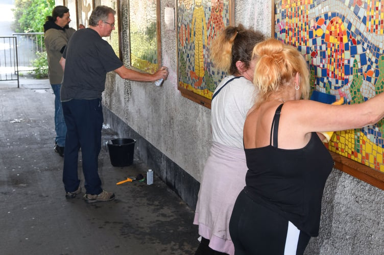 Volunteers cleaning up graffiti in a Teignmouth subway