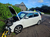 Two vehicles collide as firefighters provide first aid 