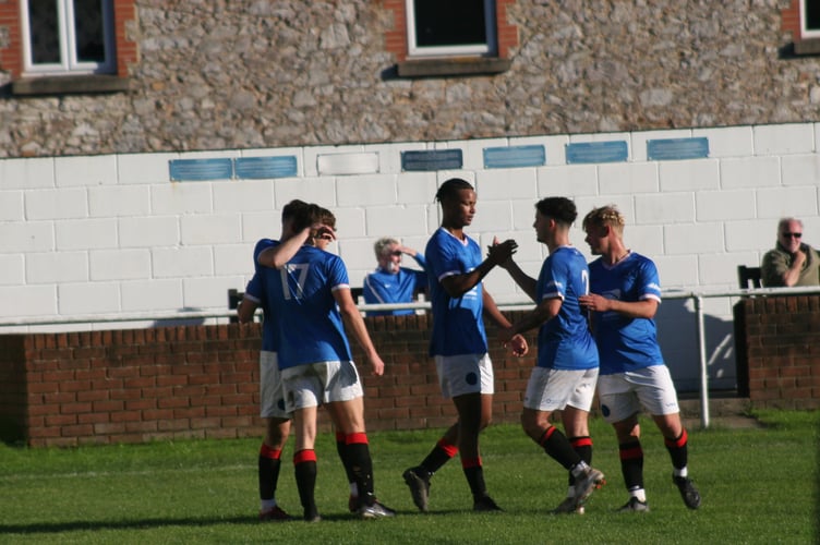 Tate Breslan-Aggrey celebrates his first of the afternoon against Millbrook with teammates