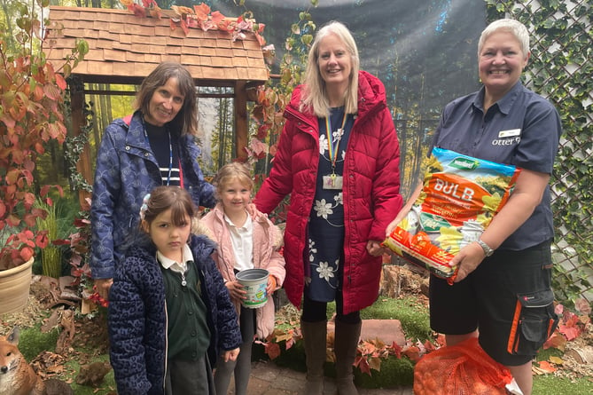 OLSP pupils Scarlett and Isla Rose and staff Trina Evans and Cathy Blatchford collect the donation of daffodil bulbs, compost and pots from Jack's Patch garden centre in Bishopsteignton