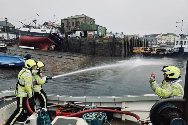 Firefighters practice dealing with a boat fire off Teignmouth's back beach