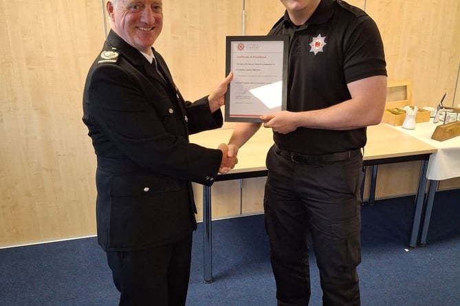 Devon and Somerset Fire and Rescue Area Manager Wayne Rawlins presents Ashburton trainee Joshua Williams with the recruits award