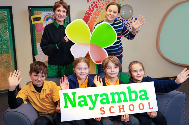 Exminster Primary School children with head Mrs Whalley and Nayamba Trust trustee Rev Vanessa Pestridge after raising money for Nayamba School dinners