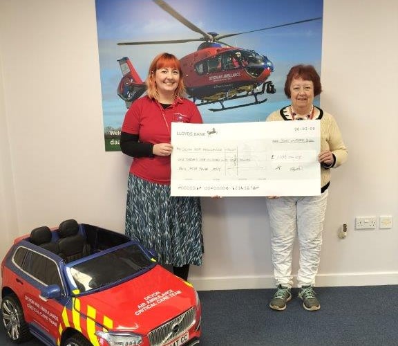 A representative from the Women's Challenge Club presents a cheque to Devon Air Ambulance - thankfully its services were never required by members of the club in the 30 years it ran outdoor activities