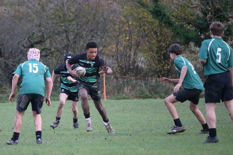 Stover U14 player prepares to deliver a hand-off in their semi-final success