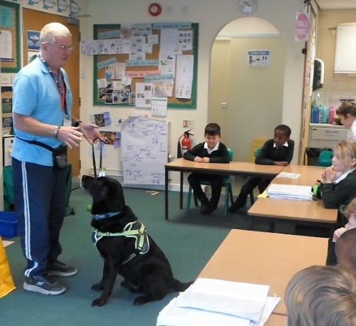 Peter Boston and Guide Dog Ridley from charity Guide Dogs at Our Lady & St Patrick Primary School Teignmouth